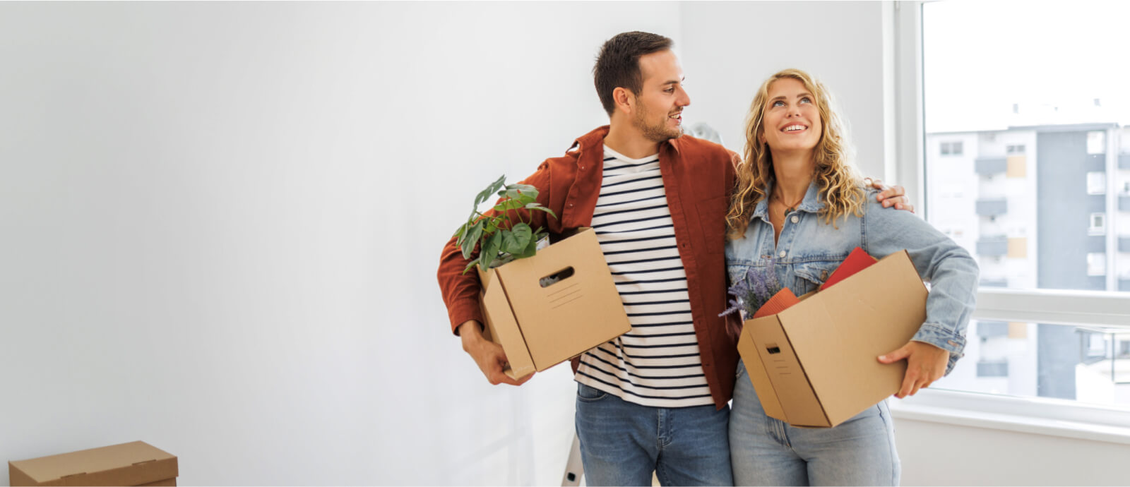 couple with boxes in new home