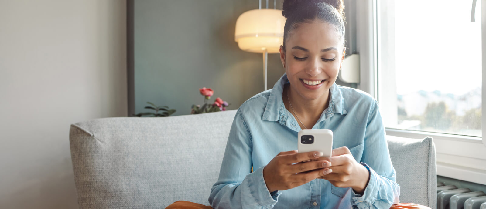 woman holding phone in living room