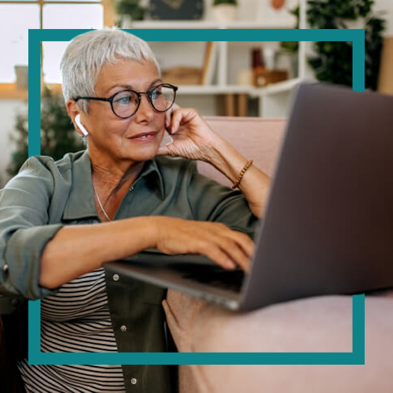 senior woman on laptop in living room