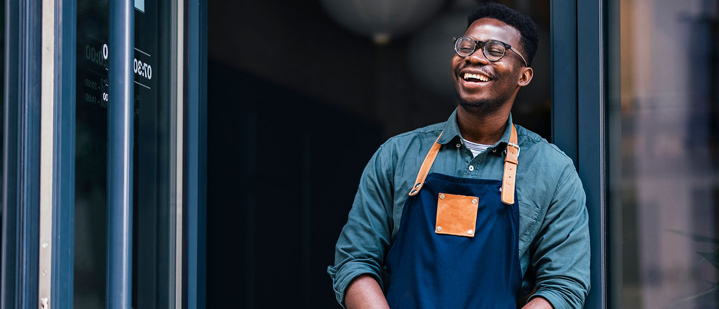 black businessman in apron smiling