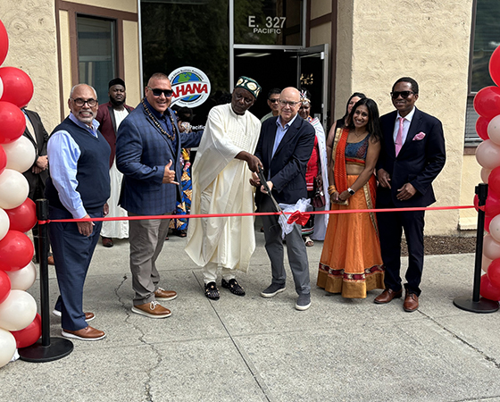 Group of Washington Trust Bank representatives help cut the ribbon at a grand opening event.