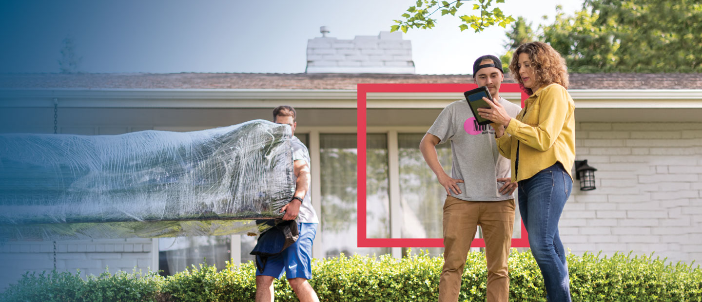 Man and woman looking at tablet couch being moved in background