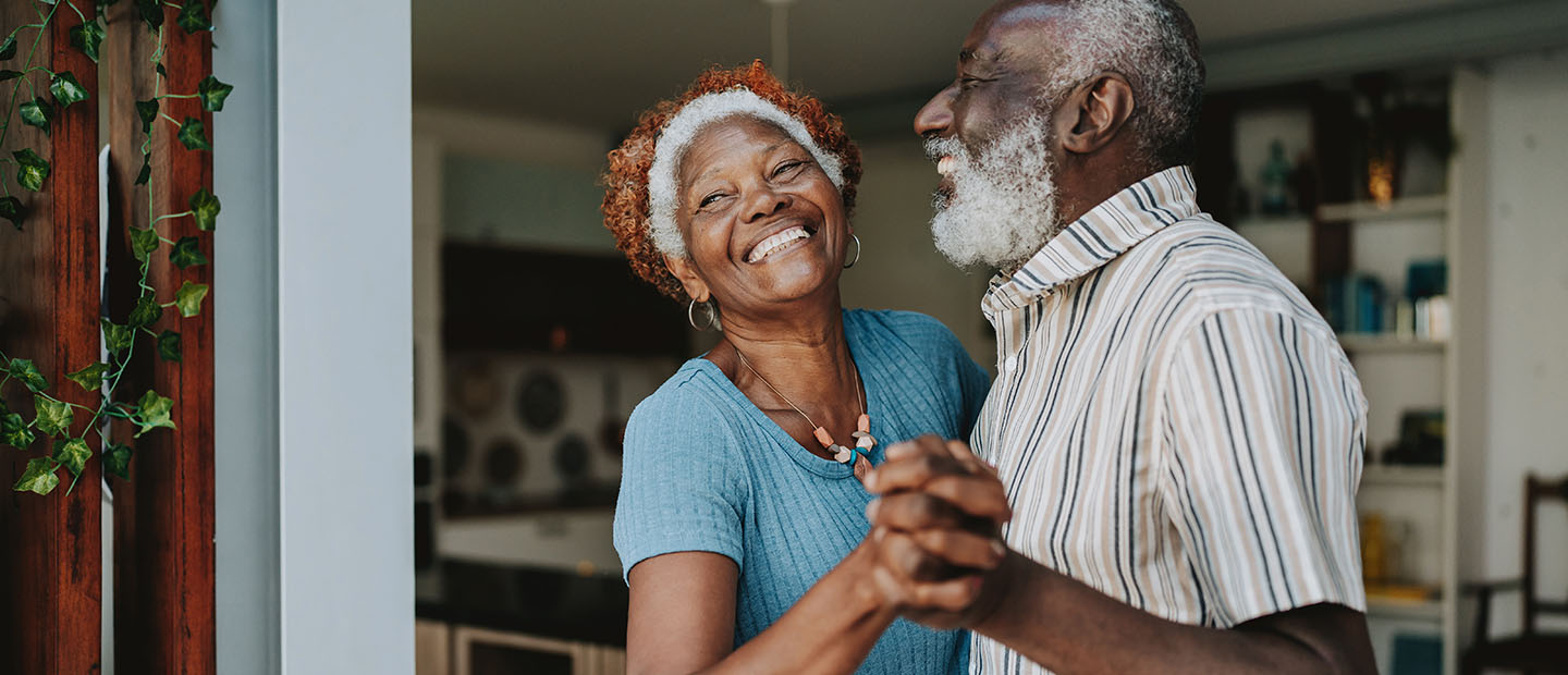 senior couple dancing at home