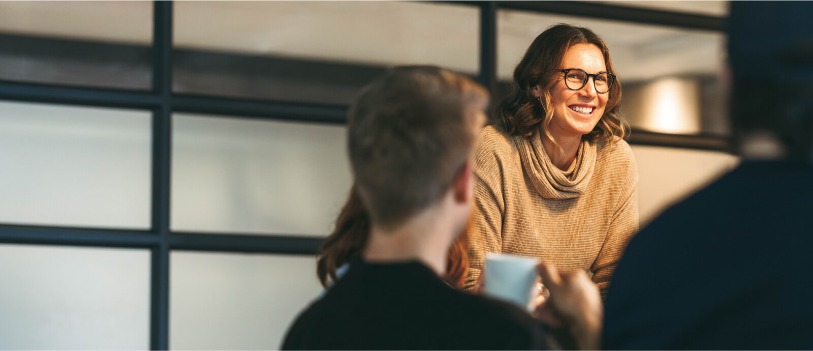 smiling woman presenting at meeting