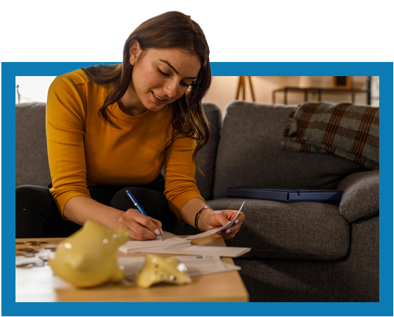 young Latina woman with paper work, pen and broken piggy bank