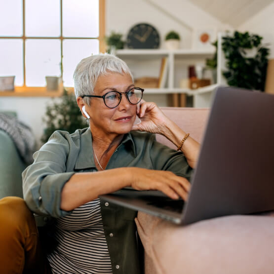 mature woman using laptop in living room