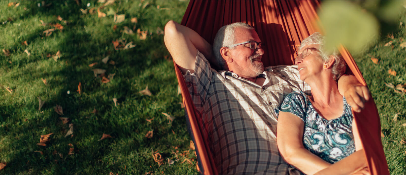 mature couple relaxing in hammock outdoors