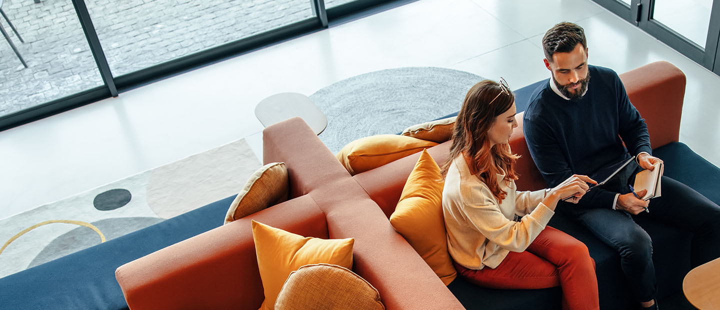 two people having a business meeting on a couch